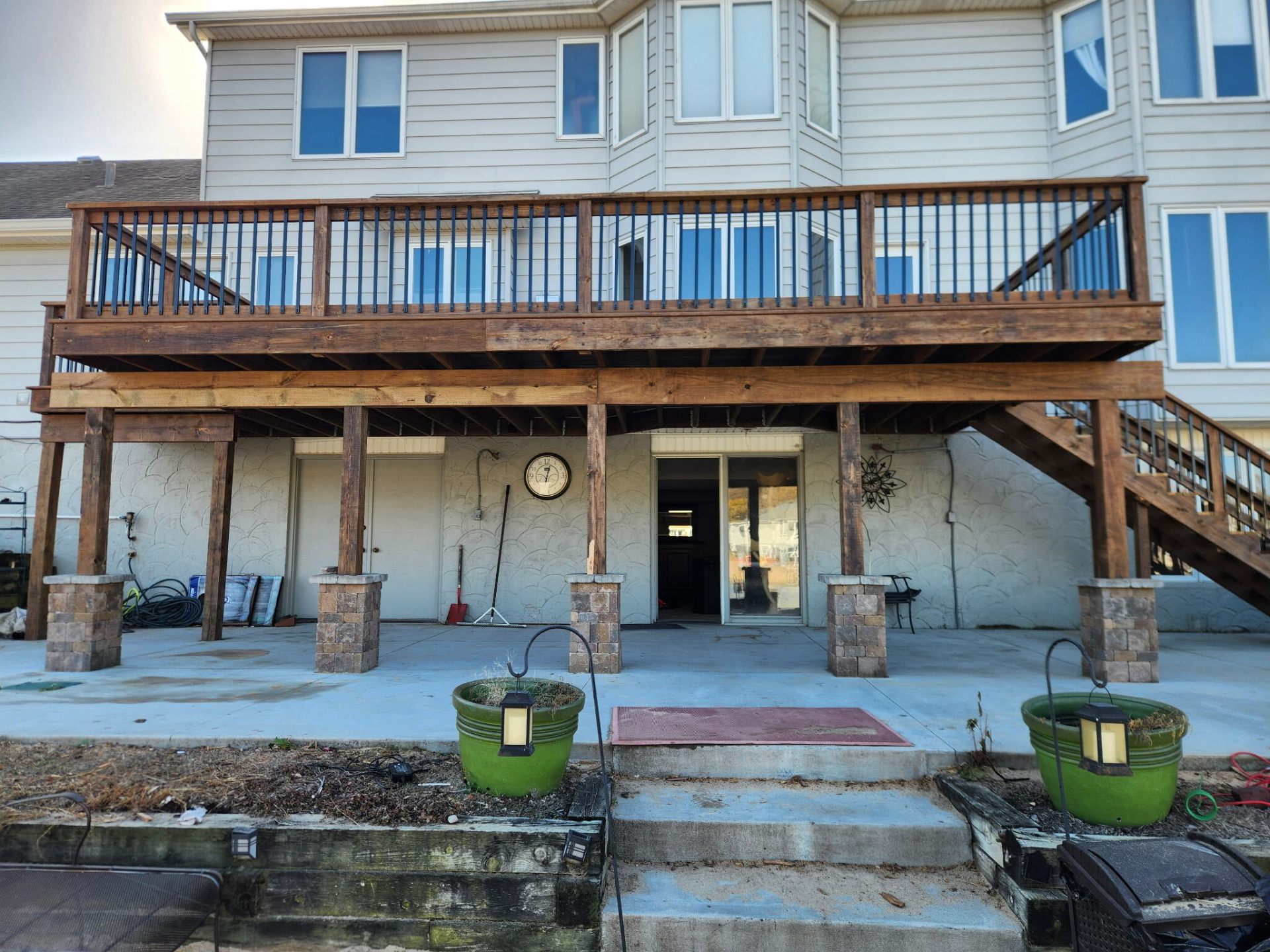 Two-story residential deck with stained wood and metal balusters