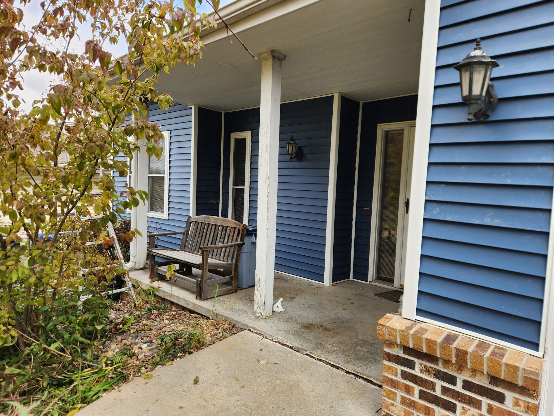 Exterior painting project — blue siding and white trim refresh