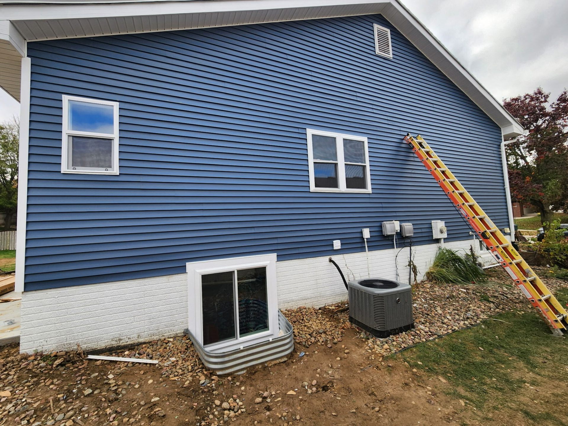 Full exterior repaint with fresh blue siding and white trim